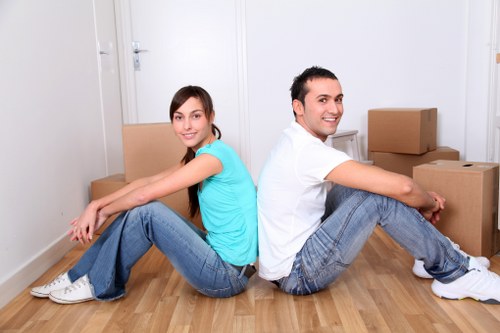 Man and van team using PPE while moving furniture safely