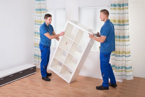 Local removal team handling furniture in a Watford street